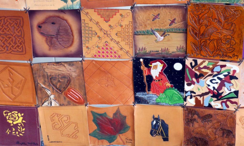 Hand-tooled leather panels made by members of the Society